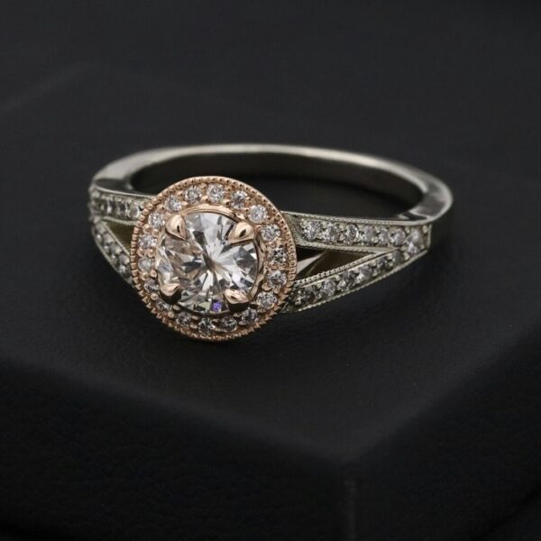 Round diamond halo ring with a rose gold halo and white gold band